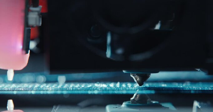Close ups of a 3D printer moving and printing an object