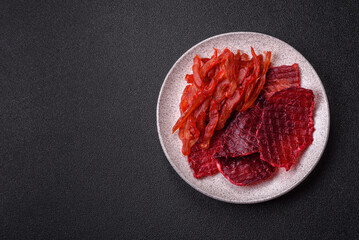 Dried beef slices, jerky, with cherry or plum flavor, salt and spices