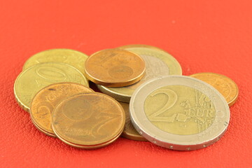 Metal Euro coins on a colored background. 