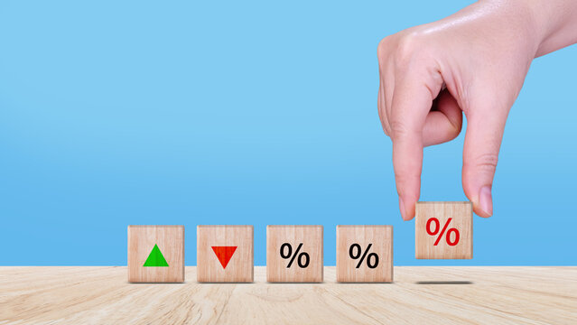 Financial, stocks, interest rate and GDP percent change, wooden block with percentage sign and arrow up sign and down for interest rate, ranking