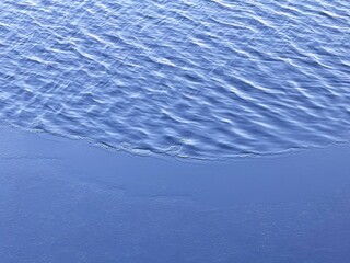 Cold river blue water ripples surface.