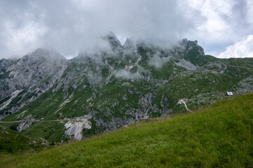 Mala Spice Cime Verdi peaks view from Mangart saddle, Slovenia's Highest Panoramic Road, heavy clouds before rain, foggy day
