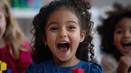 Three children are engaged in a playful activity with colorful building blocks. One girl laughs joyfully, displaying excitement. The room is filled with bright colors