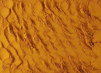 Turmeric powder pile background and texture, top view	