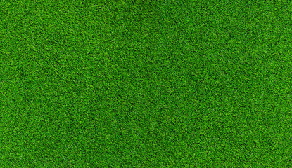 Artificial grass, covering. Artificial green grass mat, top view. Texture. Background. Artificial turf, surface made of synthetic fibers. Flat green grass texture background. Short grass