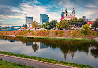 Splendid autumn view of Church of St. Archangel Raphael. Amazing morning cityscape of Vilnius, Lithuania, Europe. Beautiful outdoor scene of Neris river. Traveling concept background..