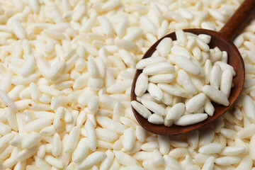 Wholegrain puffed rice and wooden spoon, closeup