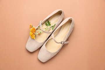 Pair of ballet flats and flowers on beige background, top view © New Africa