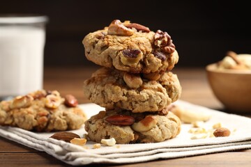 Tasty cookies with nuts on wooden table, closeup
