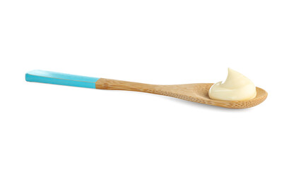 Tasty mayonnaise sauce in wooden spoon isolated on white