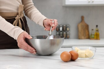 Woman making dough at white marble table indoors, closeup