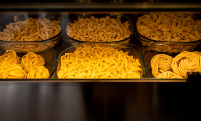 Showcase with Traditional fresh raw pasta. Concept of Italian, food, tradition and gourmet catering