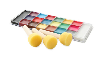 Bright face paint palette and sponges isolated on white