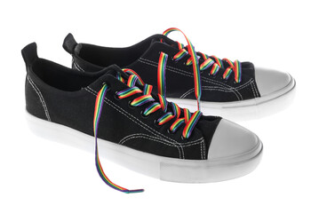 Black shoes with bright rainbow laces on white background. LGBT concept