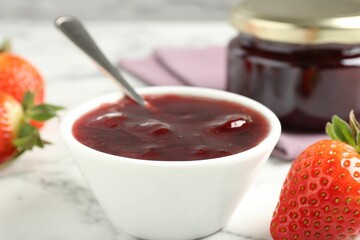 Delicious strawberry sauce and fresh berries on white marble table, closeup