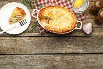 Tasty homemade pie with chicken and vegetables on wooden table, flat lay. Space for text