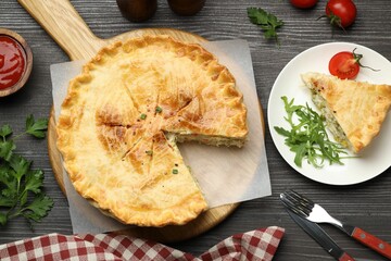 Delicious fresh homemade pie served on wooden table, flat lay