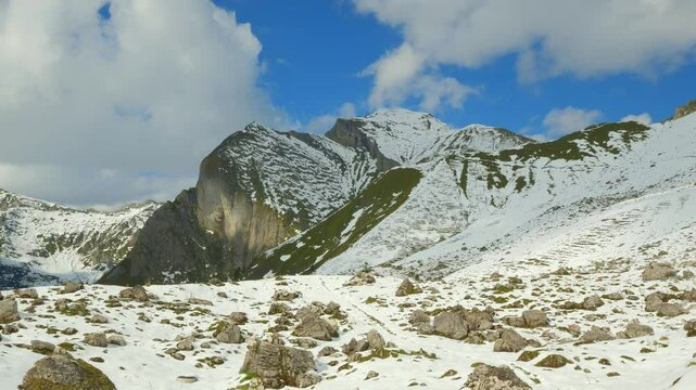 Winter in the mountains with snow-covered peaks, blue skies, and vast alpine landscapes creating the perfect scenery for skiing and a relaxing winter vacation.