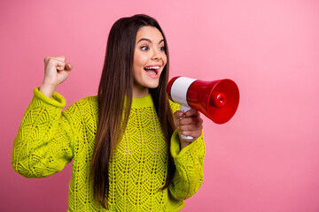 Excited Woman Holding Megaphone Against Pink Background, Smiling and Making a Victory Gesture,...
