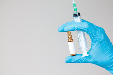 Doctor holding syringe and ampoule. Medical professional, injection, vaccine, medicine, healthcare,...