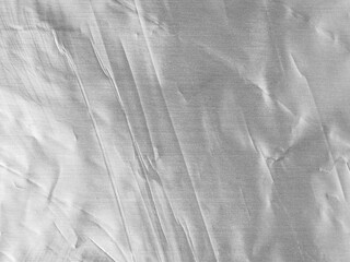 Wrinkled silver aluminum foil sheet.