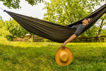 Relaxing Outdoors in a Hammock Amid a Peaceful Green Garden 