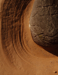 Large stone and patterns in the sand