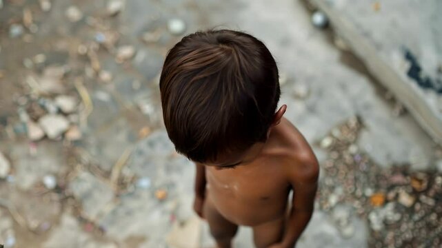 Hungry, starving, poor little child looking at the camera	