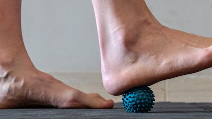 Blue spiky rubber massage ball for recovery massage. MFR ball for rehabilitation and health. Sports...