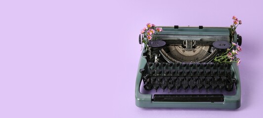 Vintage typewriter and flowers on lilac background with space for text
