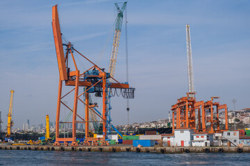 Fototapeta premium Industrial landscape of Haydarpasa port with cranes in Istanbul, Turkey. Large, busy shipping port of Haydarpasa and container ship terminal in Harem Istanbul on sunny day
