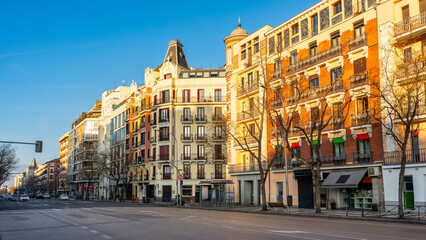 Naklejka premium Facades of classic buildings of beautiful architecture on Calle Goya in Madrid, Salamanca district.