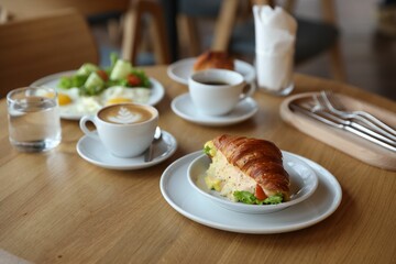 Delicious breakfast served on wooden table in cafe