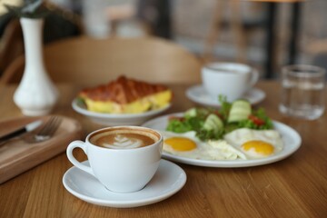 Delicious breakfast served on wooden table in cafe
