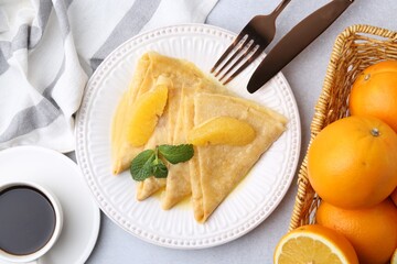 Delicious Crepes Suzette served on light table, flat lay