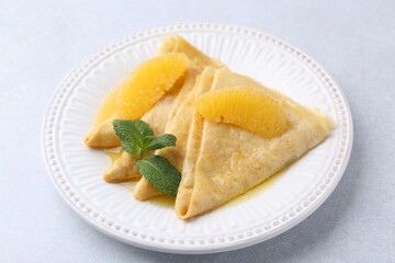 Delicious Crepes Suzette on light table, closeup