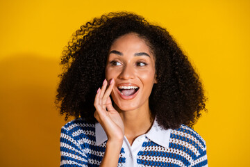Cheerful young woman in a stylish outfit expressing happiness with lively gestures against a...