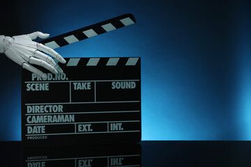 Artificial intelligence. Robot hand with clapper against dark blue background, closeup. Space for...