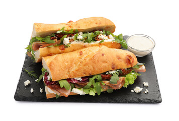 Halves of baguette sandwich with prosciutto and sun dried tomatoes isolated on white