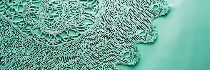 Intricate green crocheted tablecloth showcasing delicate lace design and fine texture details