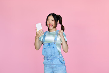 Happy excited influencer young Asian woman winner holding smartphone celebrating online game money...