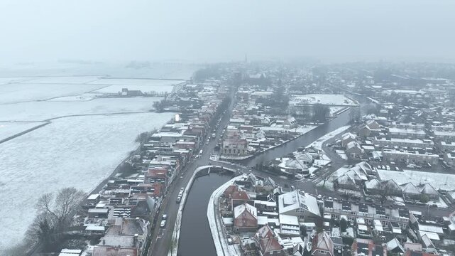 Aerial from snowy historical town Workum in Friesland in the Netherlands in winter