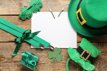 Blank card with leprechaun hats, suspenders and decor on wooden background. St. Patrick's Day...