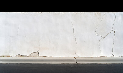 Cracked White Wall Texture with Visible Imperfections and Fissures Suitable for Various Backgrounds and Design Projects in Urban Spaces