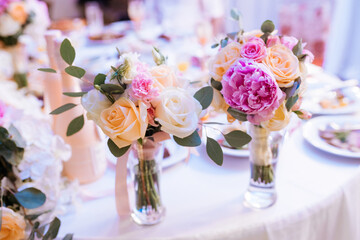 Beautiful three-tier wedding cake decorated with yellow roses and floral details.