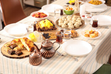 Traditional Eastern dishes for Ramadan on dining table in room, closeup