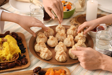 Muslim family having dinner at home, closeup. Ramadan celebration
