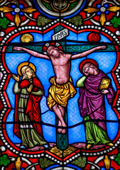 Fototapeta premium Stained glass (19th century) of Jesus Christ crucified on the cross represented with Marie and Saint John. .