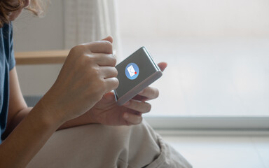 Woman hand using smartphone with 1 new mail alert sign icon. Female use phone to check email inbox for work or open text SMS message at home. Online communication business marketing technology concept