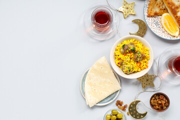 Traditional Eastern dishes, Turkish tea and Muslim decor on white background. Ramadan celebration